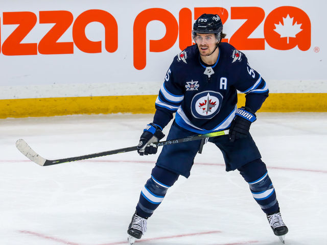 WINNIPEG, MB - APRIL 02: Mark Scheifele #55 of the Winnipeg Jets keeps an eye on the play during action in the overtime period against the Toronto Maple Leafs at Bell MTS Place on April 02, 2021 in Winnipeg, Manitoba.