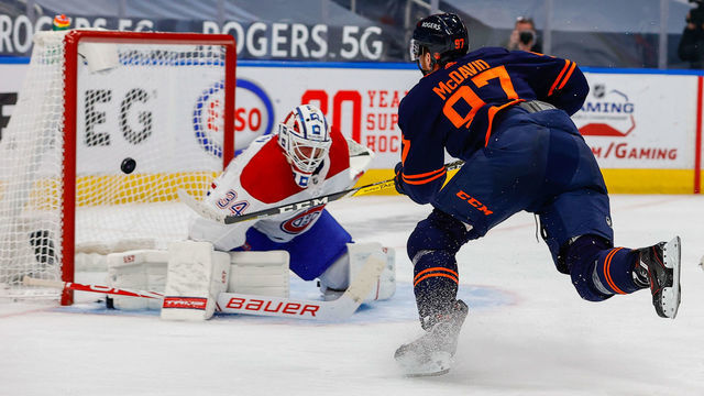 EDMONTON, AB - APRIL 19: Edmonton Oilers Center Connor McDavid (97) scores a goal on Montreal Canadiens Goalie Jake Allen (34) in the third period during the Edmonton Oilers game versus the Montreal Canadians on APRIL 19, 2021 at Rogers Place in Edmonton, AB.