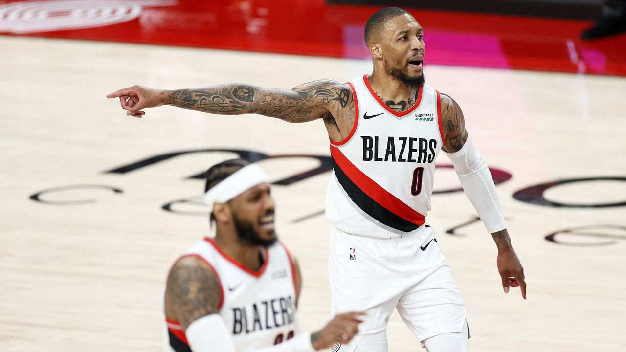 PORTLAND, OREGON - APRIL 25: Damian Lillard #0 and Carmelo Anthony #00 of the Portland Trail Blazers defend against the Memphis Grizzlies during the first quarter at Moda Center on April 25, 2021 in Portland, Oregon.