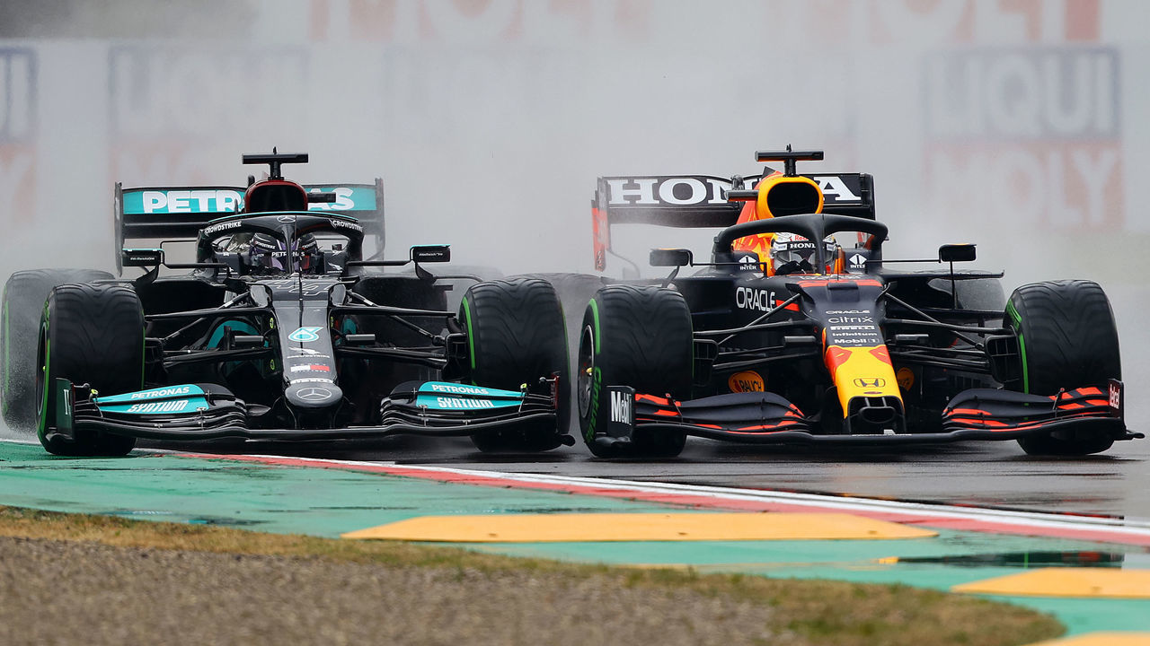 IMOLA, ITALY - APRIL 18: Max Verstappen of the Netherlands driving the (33) Red Bull Racing RB16B Honda and Lewis Hamilton of Great Britain driving the (44) Mercedes AMG Petronas F1 Team Mercedes W12 battle for track position at the start during the F1 Grand Prix of Emilia Romagna at Autodromo Enzo e Dino Ferrari on April 18, 2021 in Imola, Italy.