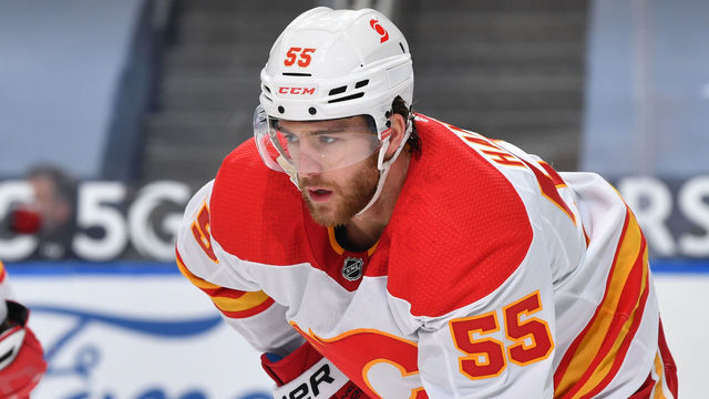 EDMONTON, AB - APRIL 2: Noah Hanifin #55 of the Calgary Flames lines up for a face off during the game against the Edmonton Oilers on April 2, 2021 at Rogers Place in Edmonton, Alberta, Canada.