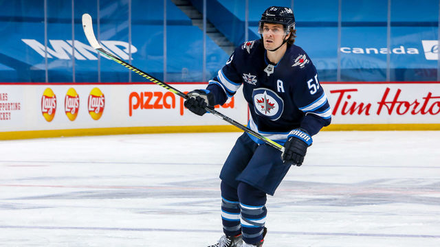 WINNIPEG, MB - APRIL 24: Mark Scheifele #55 of the Winnipeg Jets follows the play down the ice during third period action against the Toronto Maple Leafs at the Bell MTS Place on April 24, 2021 in Winnipeg, Manitoba, Canada.