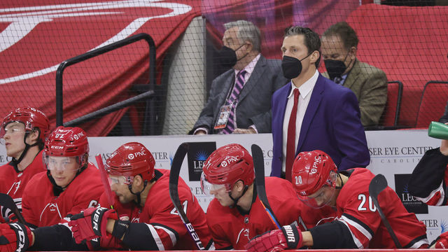 RALEIGH, NC - APRIL 17: Rod Brind'Amour head coach of the Carolina Hurricanes watches action on the ice from the bench area during an NHL game against the Nashville Predators on April 17, 2021 at PNC Arena in Raleigh, North Carolina.