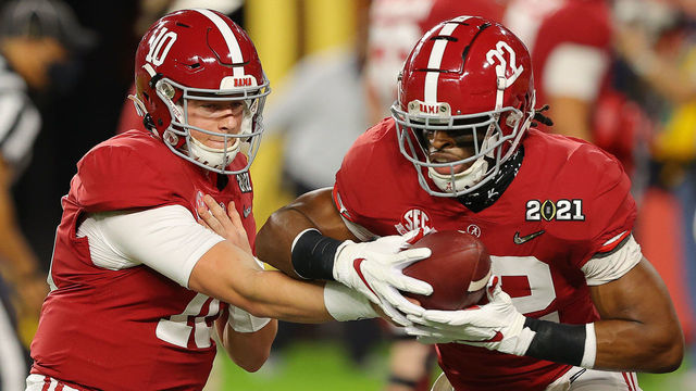 MIAMI GARDENS, FLORIDA - JANUARY 11: Mac Jones #10 and Najee Harris #22 of the Alabama Crimson Tide warm up prior to the College Football Playoff National Championship game against the Ohio State Buckeyes at Hard Rock Stadium on January 11, 2021 in Miami Gardens, Florida.