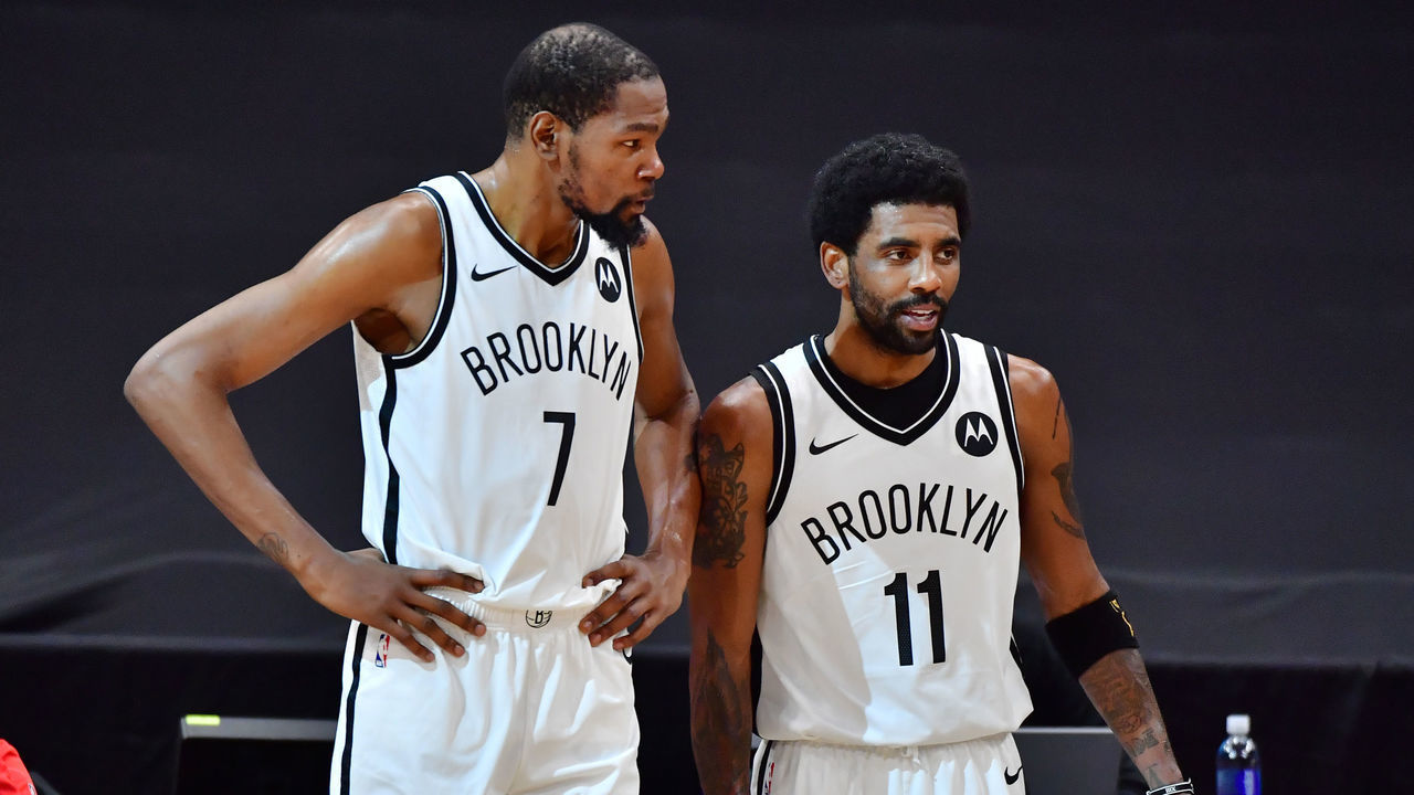 TAMPA, FLORIDA - APRIL 27: Kevin Durant #7 and Kyrie Irving #11 of the Brooklyn Nets converse during the first half against the Toronto Raptors at Amalie Arena on April 27, 2021 in Tampa, Florida.