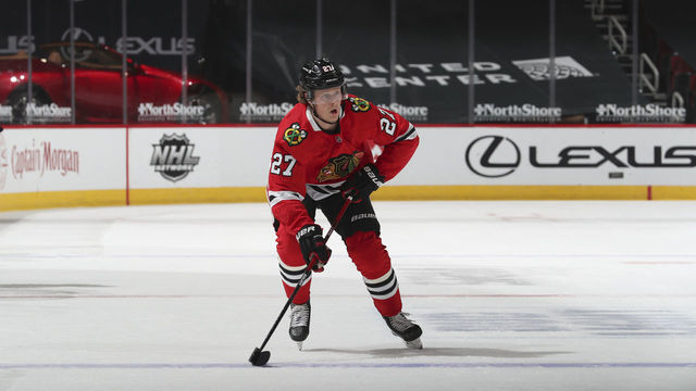 CHICAGO, ILLINOIS - FEBRUARY 27: Adam Boqvist #27 of the Chicago Blackhawks skates with the puck against the Detroit Red Wings in the first period at the United Center on February 27, 2021 in Chicago, Illinois.