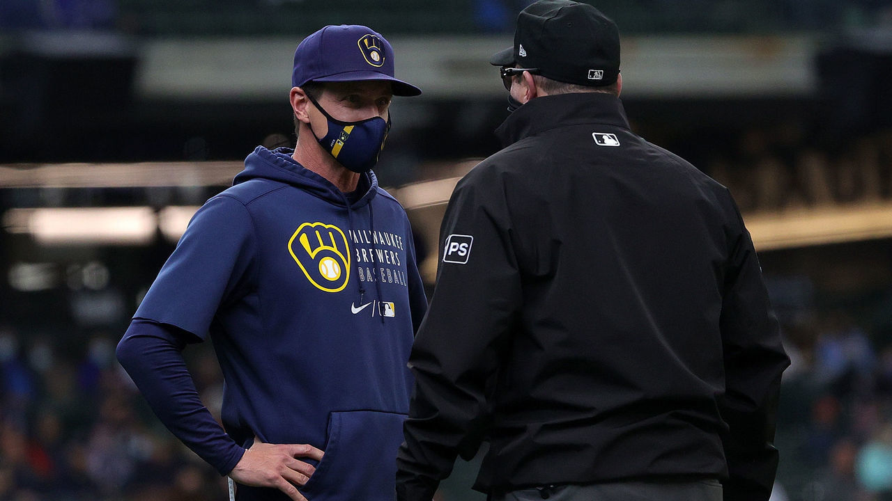 MILWAUKEE, WISCONSIN - APRIL 28: Manager Craig Counsell #30 of the Milwaukee Brewers discusses a call with umpire Marty Foster #60 during the second inning against the Miami Marlinsat American Family Field on April 28, 2021 in Milwaukee, Wisconsin.