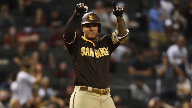 PHOENIX, ARIZONA - APRIL 28: Manny Machado #13 of the San Diego Padres gestures to his dugout after hitting a three run triple against the Arizona Diamondbacks during the fifth inning at Chase Field on April 28, 2021 in Phoenix, Arizona.