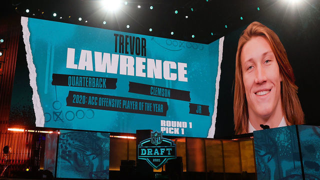 CLEVELAND, OHIO - APRIL 29: Screens show the Jacksonville Jaguars selection of Trevor Lawrence with the first pick of the 2021 NFL Draft at the Great Lakes Science Center on April 29, 2021 in Cleveland, Ohio.