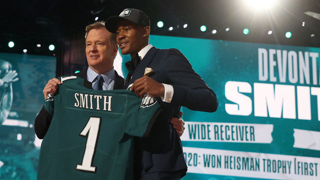 CLEVELAND, OHIO - APRIL 29: DeVonta Smith poses with NFL Commissioner Roger Goodell onstage after being selected 10th by the Philadelphia Eagles during round one of the 2021 NFL Draft at the Great Lakes Science Center on April 29, 2021 in Cleveland, Ohio.