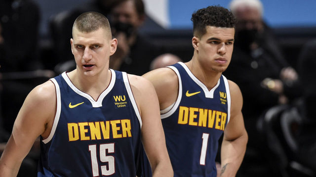 DENVER, CO - APRIL 29: Nikola Jokic (15) of the Denver Nuggets talks to OG Anunoby (3) of the Toronto Raptors as he and teammate Michael Porter Jr. (1) take the floor during the first quarter at Ball Arena on Thursday, April 29, 2021.