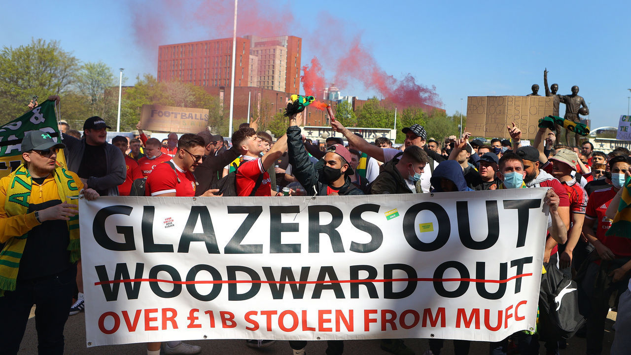 MANCHESTER, ENGLAND - APRIL 24: Manchester United supporters protest against the Glazer ownership during a protest against the club's ownership, outside Old Trafford on April 24, 2021 in Manchester, England. The protest, which takes place amid growing discontent over running of Manchester United, was sparked by the club's recent involvement in the European Super League. There was uproar from football fans across the country earlier this week when six major Premier League football clubs, including Manchester United, announced that they were to join the controversial "closed-shop" tournament. Each club has subsequently withdrawn from the competition.