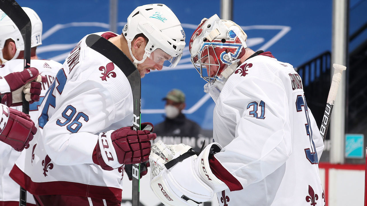 DENVER, COLORADO - MARCH 25: Goaltender Philipp Grubauer #31 of the Colorado Avalanche celebrates a win against the Vegas Golden Knights with teammate Mikko Rantanen #96 at Ball Arena on March 25, 2021 in Denver, Colorado. The Avalanche defeated the Golden Knights 5-1.