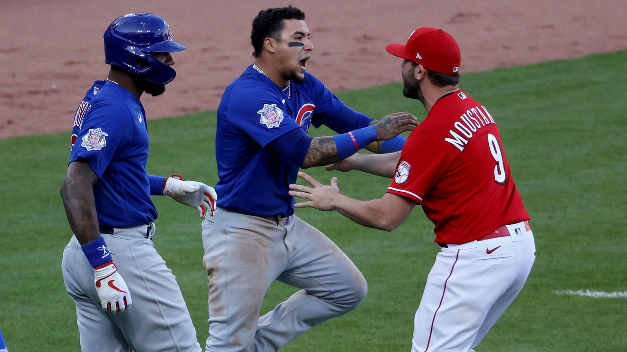 CINCINNATI, OHIO - MAY 01: Mike Moustakas #9 of the Cincinnati Reds confronts Javier Baez #9 of the Chicago Cubs during a bench clearing incident in the eighth inning at Great American Ball Park on May 01, 2021 in Cincinnati, Ohio.