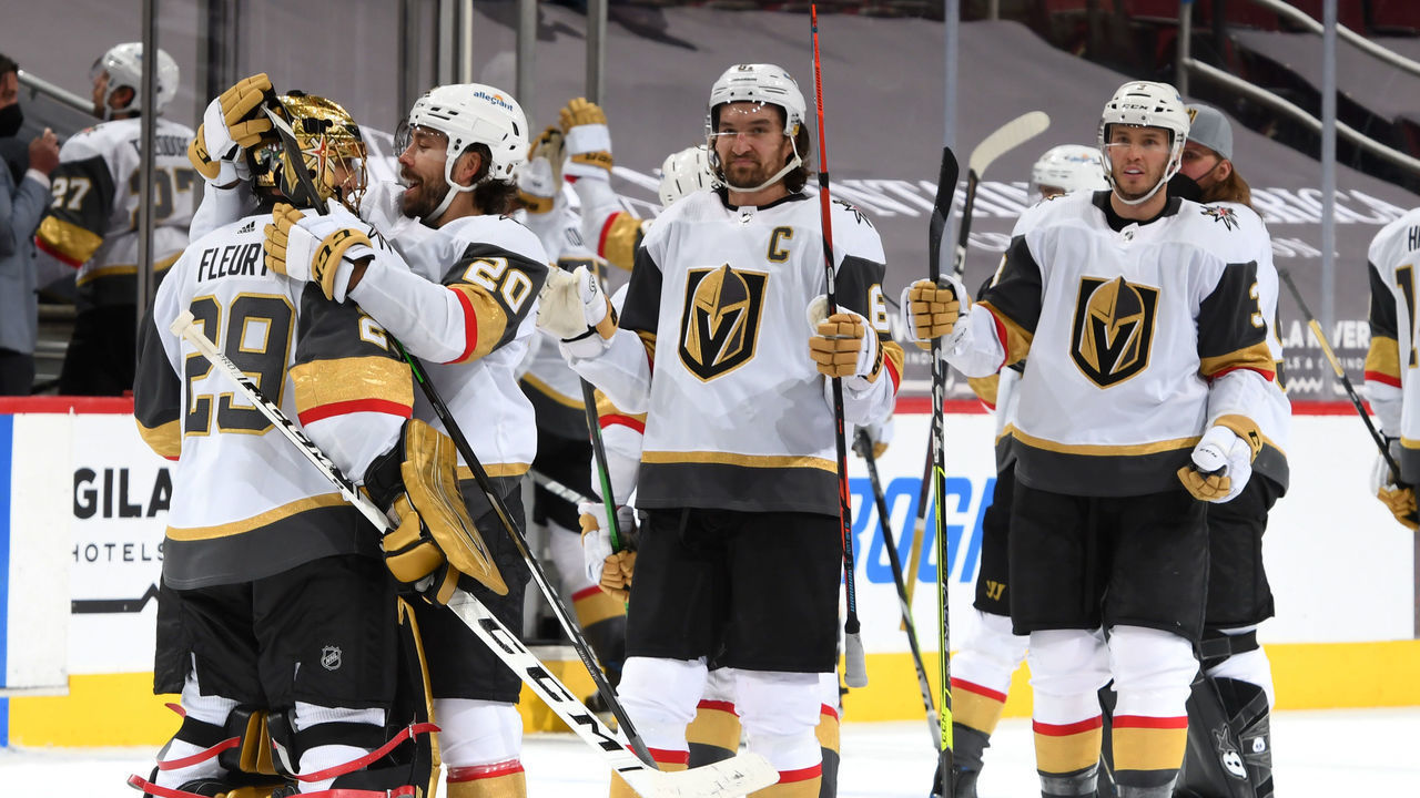 GLENDALE, ARIZONA - MAY 01: Goalie Marc-Andre Fleury #29 of the Vegas Golden Knights is congratulated by Chandler Stephenson #20 of the Golden Knights and teammates after a 3-2 overtime victory against the Arizona Coyotes during the NHL hockey game at Gila River Arena on May 01, 2021 in Glendale, Arizona.