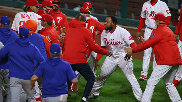 PHILADELPHIA, PA - APRIL 30: Jose Alvarado #46 of the Philadelphia Phillies is held back manager Joe Girardi #25, right, and teammates after he and Dominic Smith #2 of the New York Mets exchanged words after a strikeout and both dugouts emptied onto the field during the eighth inning of a game at Citizens Bank Park on April 30, 2021 in Philadelphia, Pennsylvania. The Phillies defeated the Mets 2-1.