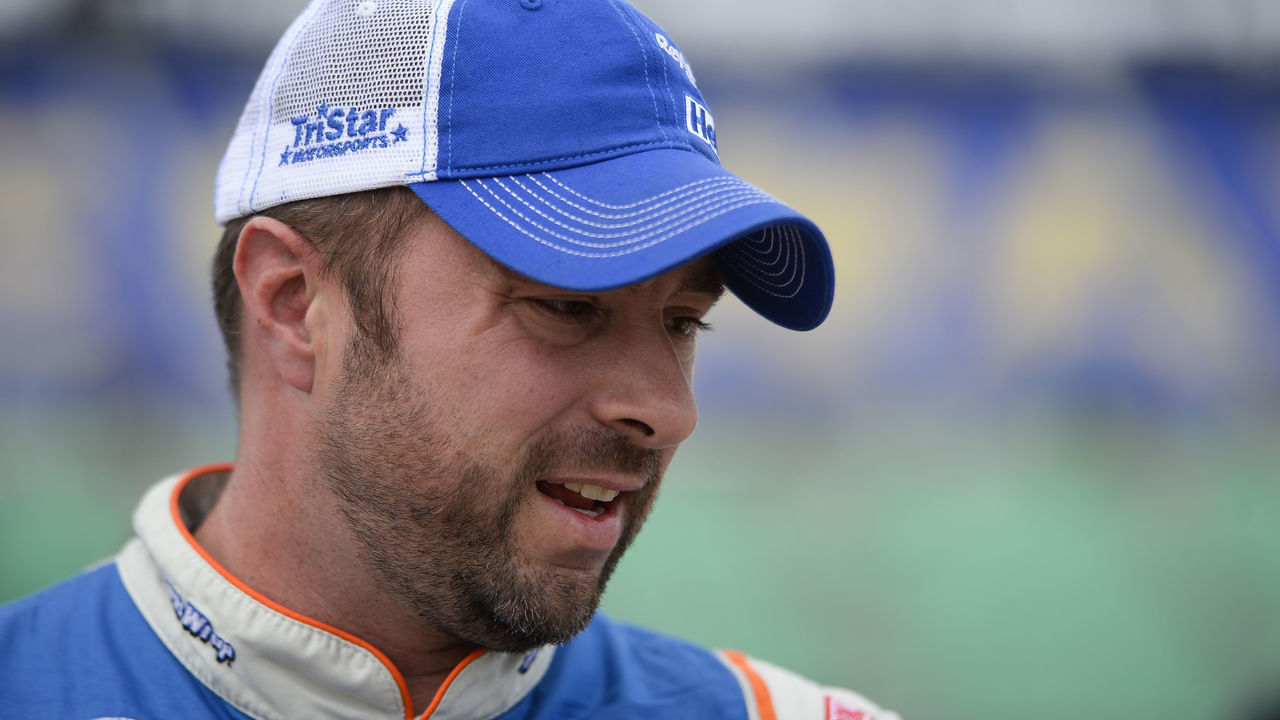 Eric McClure, driver of the #24 Reynolds Wrap Toyota, stands in the garage area during qualifying for the NASCAR XFINITY Series Kansas Lottery 300 at Kansas Speedway on October 17, 2015 in Kansas City, Kansas.