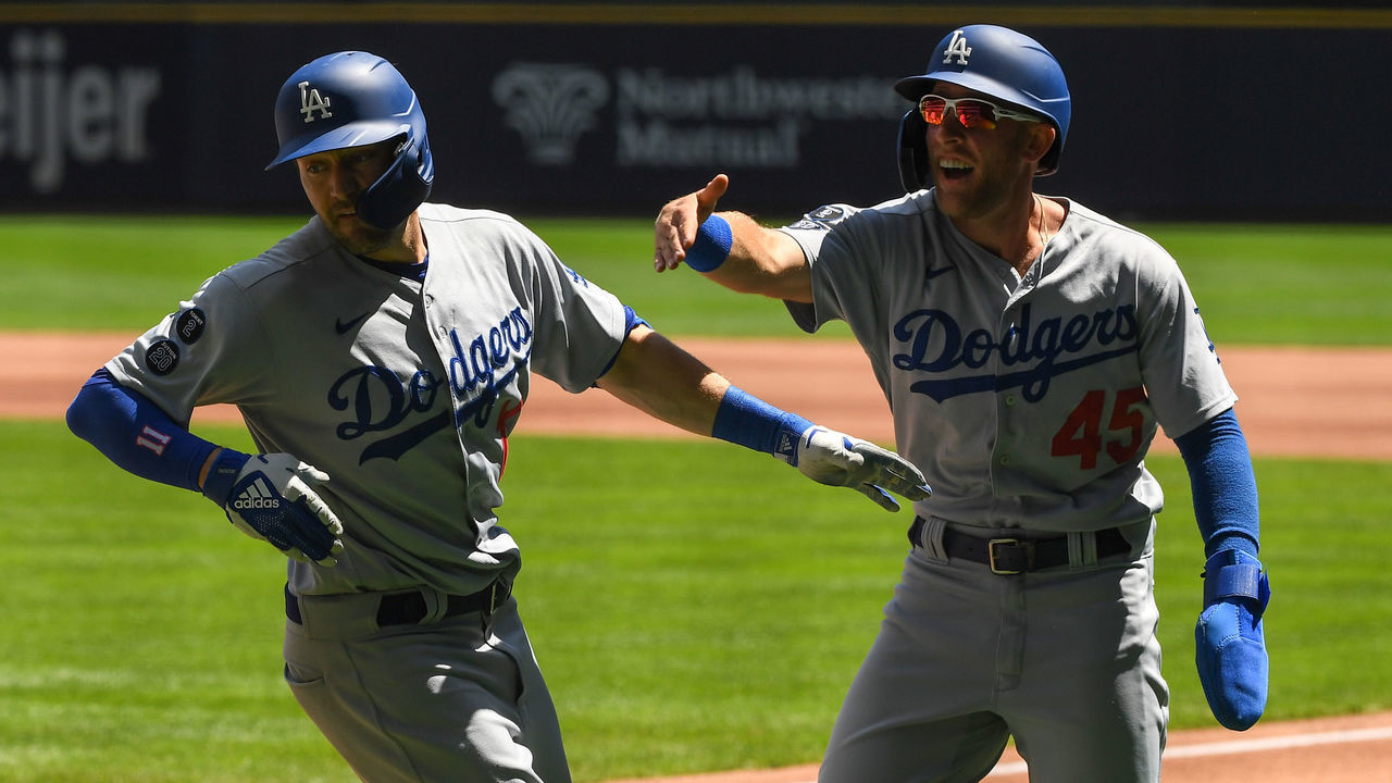 MILWAUKEE, WISCONSIN - MAY 02: Matt Beaty #45 of the Los Angeles Dodgers congratulates AJ Pollock #11 of the Los Angeles Dodgers for his grand slam in the first inning against the Milwaukee Brewers at American Family Field on May 02, 2021 in Milwaukee, Wisconsin.