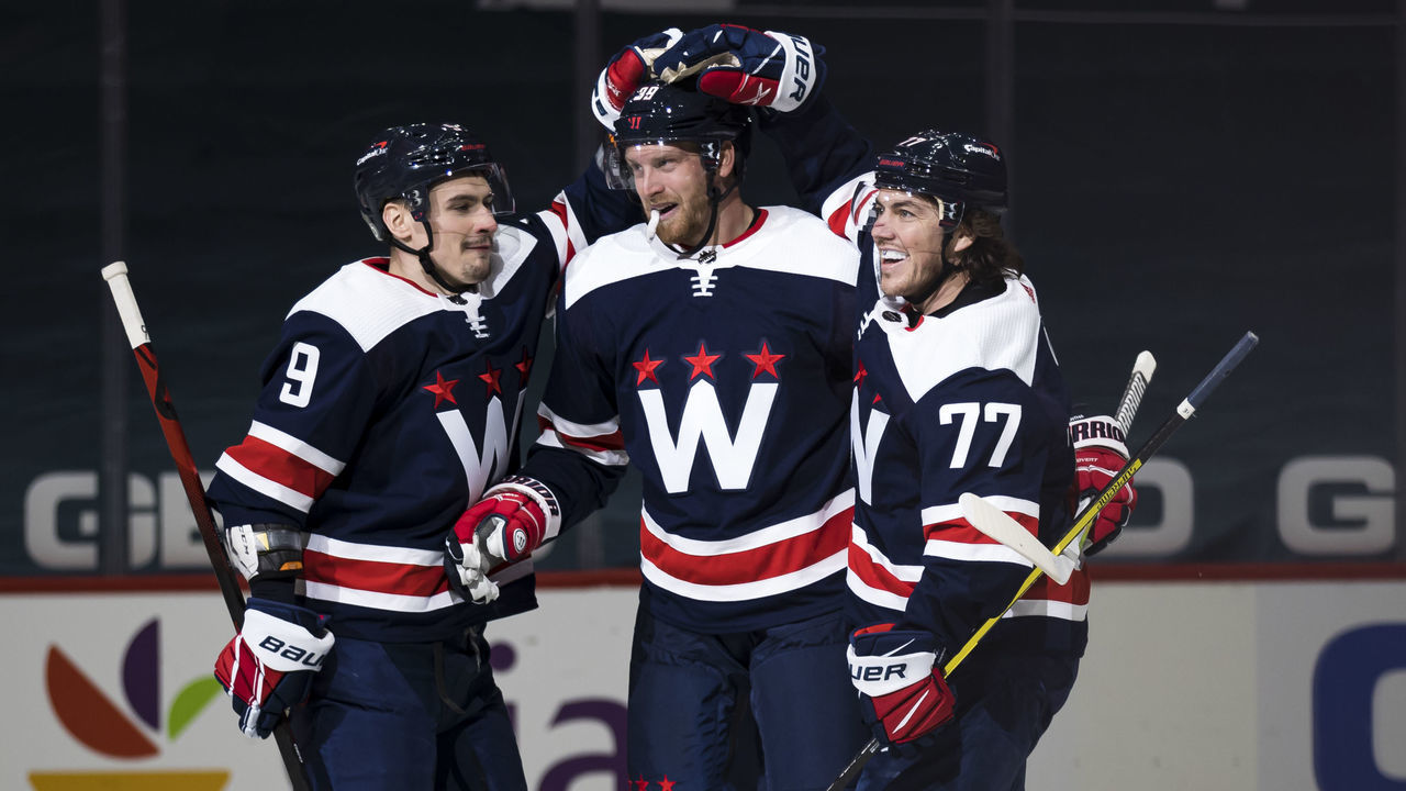 WASHINGTON, DC - APRIL 15: Anthony Mantha #39 of the Washington Capitals celebrates with T.J. Oshie #77 and Dmitry Orlov #9 after scoring a goal against the Buffalo Sabres during the second period at Capital One Arena on April 15, 2021 in Washington, DC.