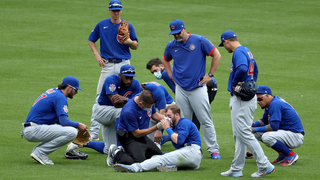 CINCINNATI, OHIO - MAY 02: Ian Happ #8 of the Chicago Cubs is looked at by a trainer after colliding with Nico Hoerner #2 in the eighth inning against the Cincinnati Reds at Great American Ball Park on May 02, 2021 in Cincinnati, Ohio.