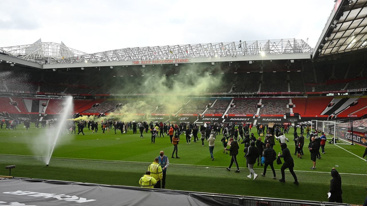 TOPSHOT - Supporters protest against Manchester United's owners, inside English Premier League club Manchester United's Old Trafford stadium in Manchester, north west England on May 2, 2021, ahead of their English Premier League fixture against Liverpool. - Manchester United were one of six Premier League teams to sign up to the breakaway European Super League tournament. But just 48 hours later the Super League collapsed as United and the rest of the English clubs pulled out.