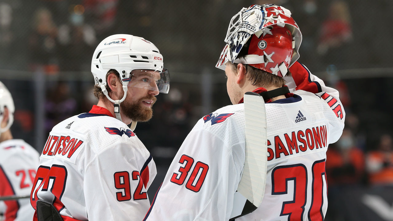 PHILADELPHIA, PA - APRIL 17: Ilya Samsonov #30 and Evgeny Kuznetsov #92 of the Washington Capitals gather during a timeout against the Philadelphia Flyers at the Wells Fargo Center on April 17, 2021 in Philadelphia, Pennsylvania.