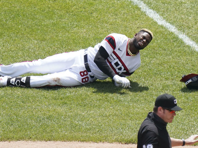 CHICAGO, ILLINOIS - MAY 02: Luis Robert #88 of the Chicago White Sox gets injured after reaching first base on a single during the first inning of a game against the Cleveland Indians at Guaranteed Rate Field on May 02, 2021 in Chicago, Illinois.