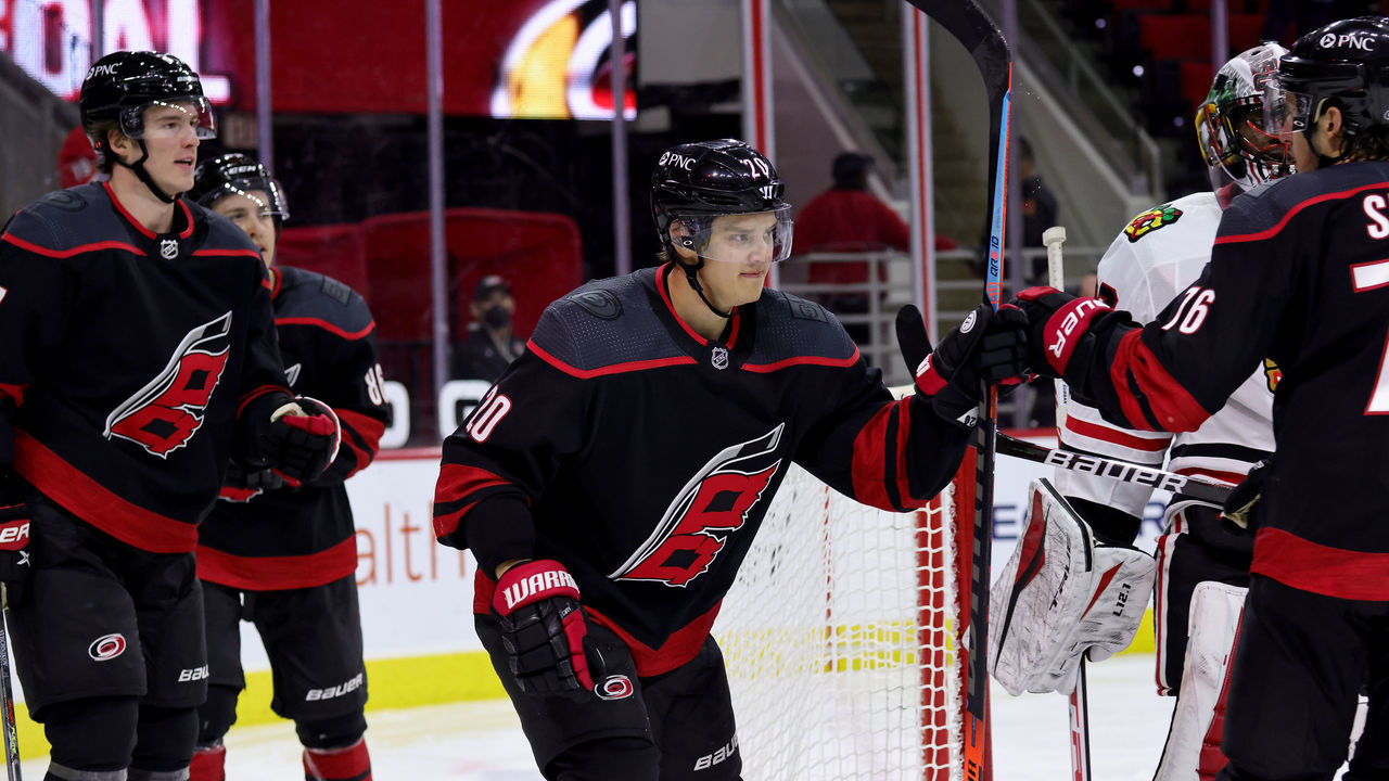 RALEIGH, NC - MAY 3: Sebastian Aho #20 of the Carolina Hurricanes scores a goal and celebrates with teammates during an NHL game against the Chicago Blackhawks on May 3, 2021 at PNC Arena in Raleigh, North Carolina.
