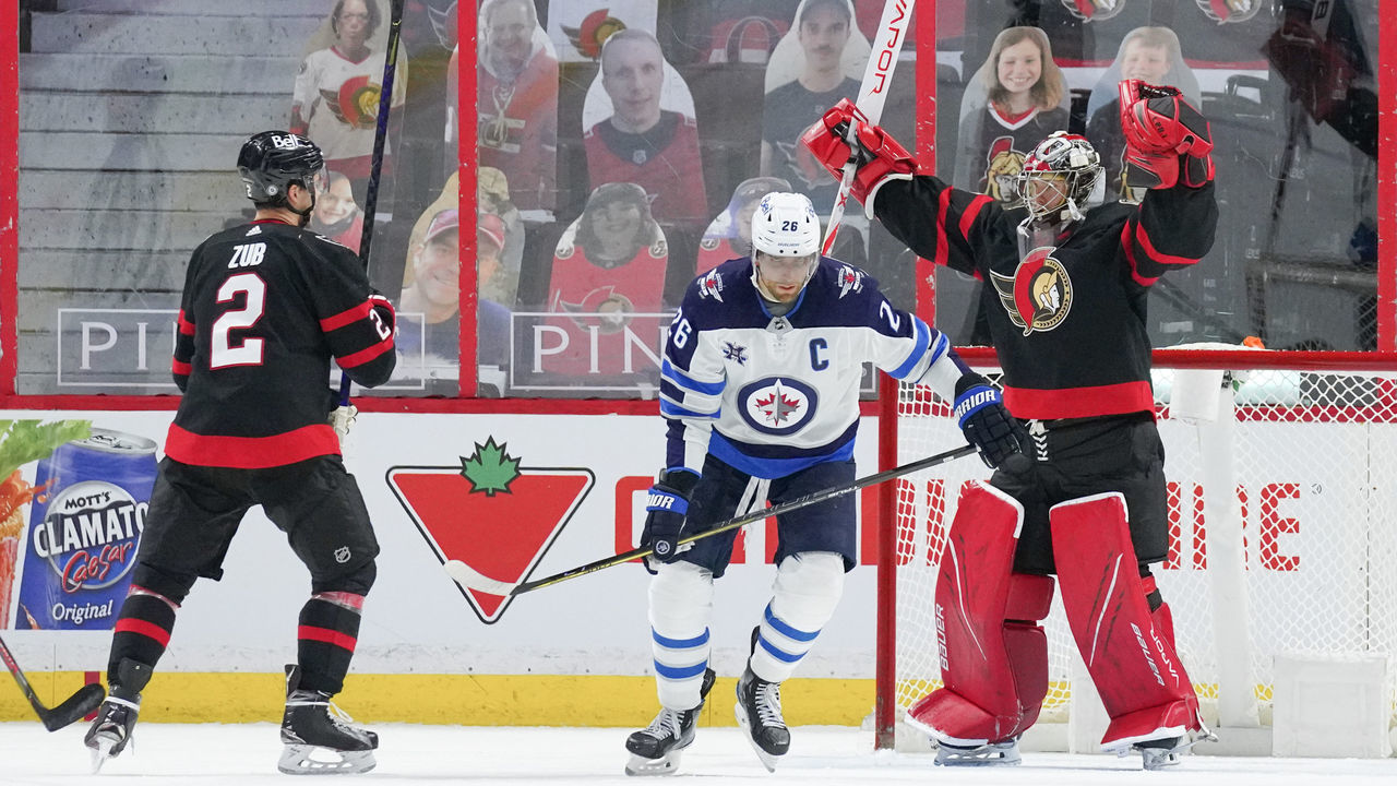 OTTAWA, ON - MAY 3: Filip Gustavsson #32 of the Ottawa Senators celebrates his 2-1 win over Blake Wheeler #26 and the Winnipeg Jets with teammate Artem Zub #2 at Canadian Tire Centre on May 3, 2021 in Ottawa, Ontario, Canada.