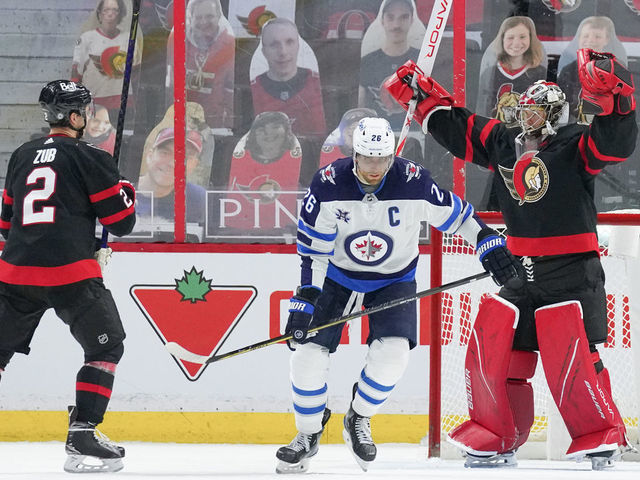 OTTAWA, ON - MAY 3: Filip Gustavsson #32 of the Ottawa Senators celebrates his 2-1 win over Blake Wheeler #26 and the Winnipeg Jets with teammate Artem Zub #2 at Canadian Tire Centre on May 3, 2021 in Ottawa, Ontario, Canada.