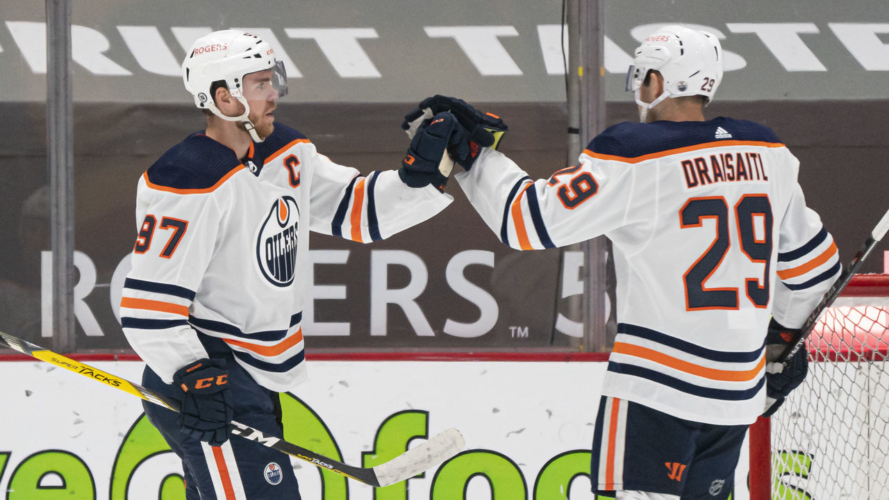 VANCOUVER, BC - MAY 03: Connor McDavid #97 of the Edmonton Oilers celebrates with teammate Leon Draisaitl #29 after scoring a goal against the Vancouver Canucks during the second period at Rogers Arena on May 3, 2021 in Vancouver, Canada.