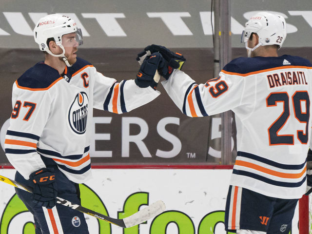 VANCOUVER, BC - MAY 03: Connor McDavid #97 of the Edmonton Oilers celebrates with teammate Leon Draisaitl #29 after scoring a goal against the Vancouver Canucks during the second period at Rogers Arena on May 3, 2021 in Vancouver, Canada.