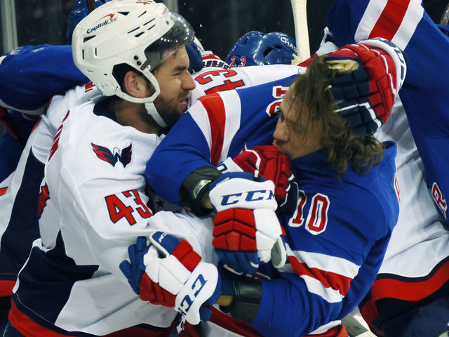 NEW YORK, NEW YORK - MAY 03: Tom Wilson #43 of the Washington Capitals takes a roughing penalty during the second period against Artemi Panarin #10 of the New York Rangers at Madison Square Garden on May 03, 2021 in New York City.