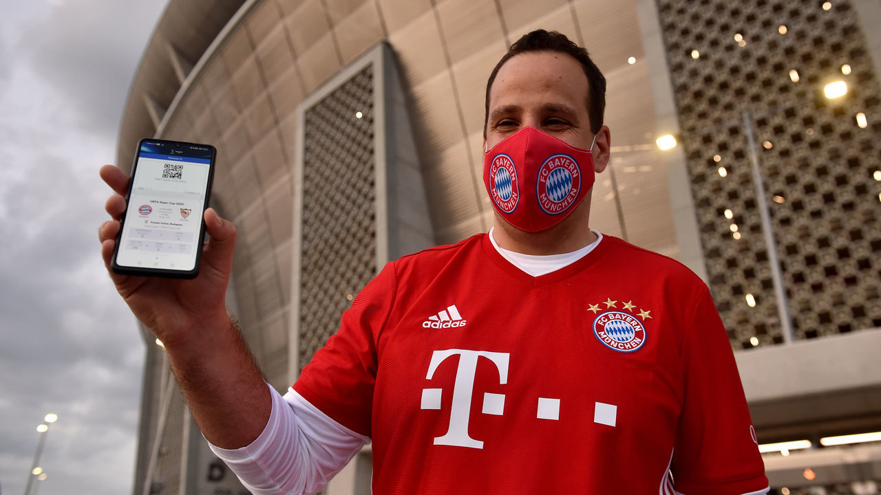 BUDAPEST, HUNGARY - SEPTEMBER 24: A Bayern Munich fan shows off his match ticket on his phone prior to the UEFA Super Cup match between FC Bayern Munich and FC Sevilla at Puskas Arena on September 24, 2020 in Budapest, Hungary. 20,000 fans have been allowed into the ground as COVID-19 restrictions ease.