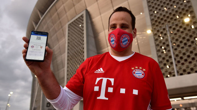 BUDAPEST, HUNGARY - SEPTEMBER 24: A Bayern Munich fan shows off his match ticket on his phone prior to the UEFA Super Cup match between FC Bayern Munich and FC Sevilla at Puskas Arena on September 24, 2020 in Budapest, Hungary. 20,000 fans have been allowed into the ground as COVID-19 restrictions ease.