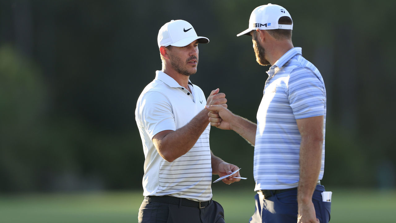 BRADENTON, FLORIDA - FEBRUARY 26: (L-R) Brooks Koepka of the United States and Dustin Johnson of the United States fist bump on the 18th green during the second round of World Golf Championships-Workday Championship at The Concession on February 26, 2021 in Bradenton, Florida.