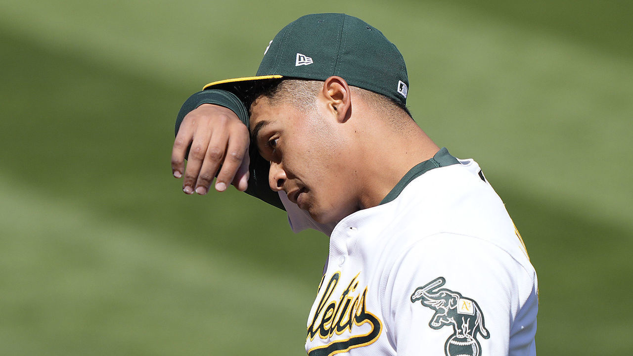 OAKLAND, CALIFORNIA - APRIL 07: Jesus Luzardo #44 of the Oakland Athletics wipes the sweat from his forehead as he walks back to the dugout after being taken out of the game against the Los Angeles Dodgers in the sixth inning at RingCentral Coliseum on April 07, 2021 in Oakland, California.