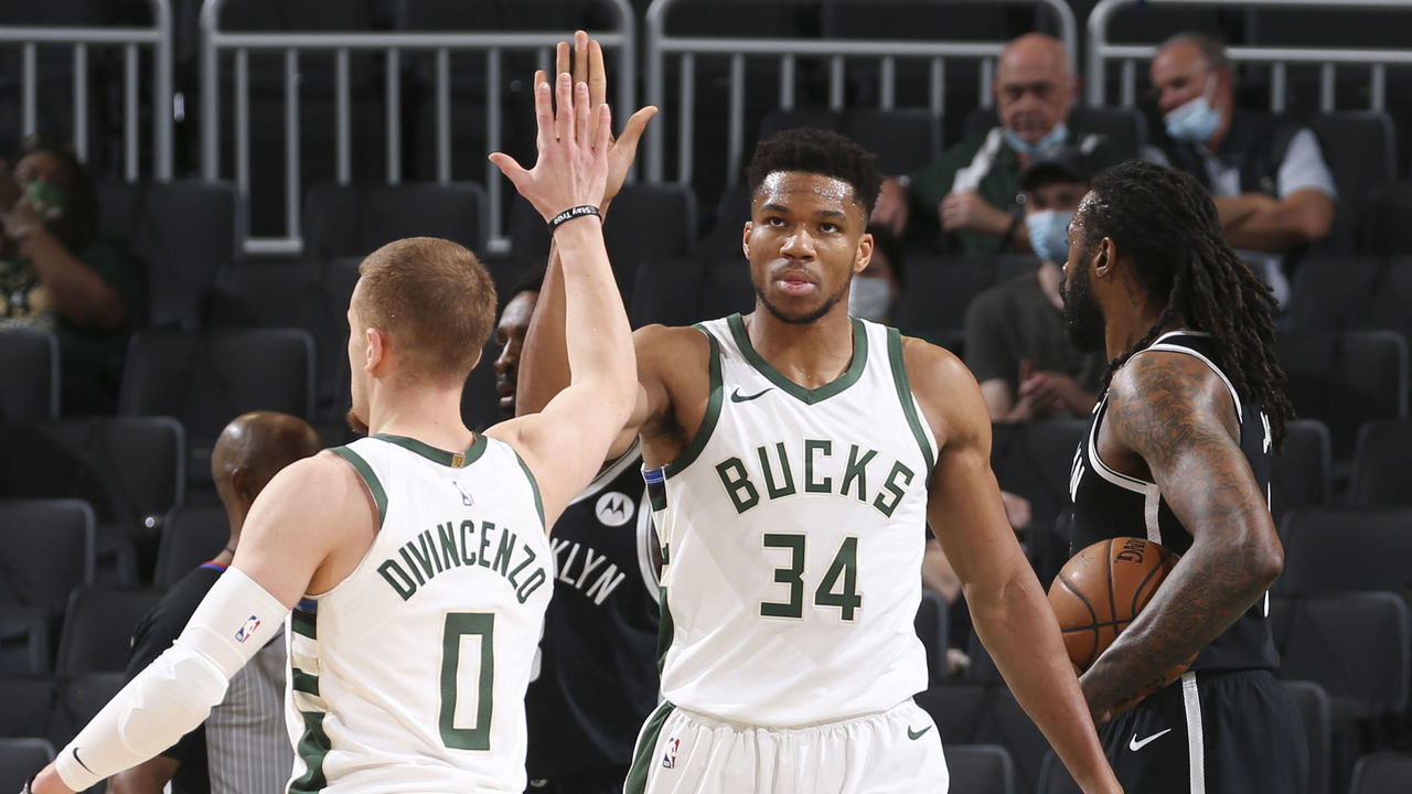 MILWAUKEE, WI - MAY 4: Giannis Antetokounmpo #34 of the Milwaukee Bucks high fives Donte DiVincenzo #0 of the Milwaukee Bucks during the game against the Brooklyn Nets on May 4, 2021 at the Fiserv Forum Center in Milwaukee, Wisconsin. Mandatory Copyright Notice: Copyright 2021 NBAE .