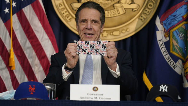 NEW YORK, NEW YORK - MARCH 18: New York Governor Andrew Cuomo shows off a mask that has both New York Yankees and New York Mets logos during an event at his office on March 18, 2021 in New York City. Cuomo spoke about the return of spectators to performing arts and sporting events, including a limited amount of fans attending baseball games at the start of the season.