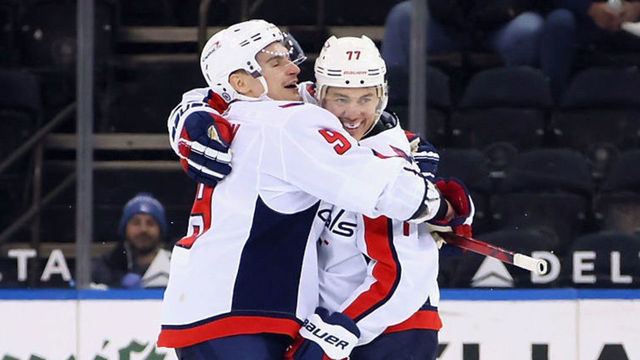NEW YORK, NEW YORK - MAY 05: T.J. Oshie #77 of the Washington Capitals celebrates his hattrick goal at 18:20 of the third period against the New York Rangers as he is hugged by Dmitry Orlov #9 at at Madison Square Garden on May 05, 2021 in New York City. The Capitals defeated the Rangers 4-2.