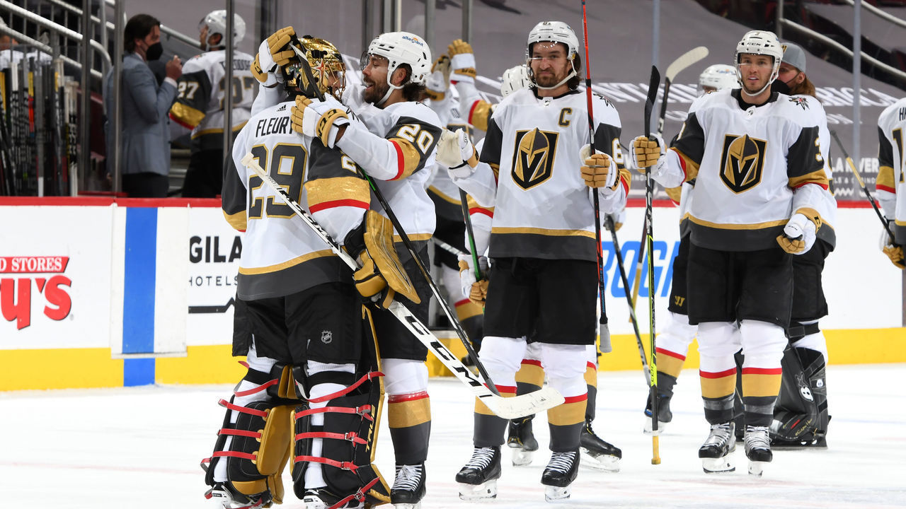 GLENDALE, ARIZONA - MAY 01: Goalie Marc-Andre Fleury #29 of the Vegas Golden Knights is congratulated by Chandler Stephenson #20 of the Golden Knights and teammates after a 3-2 overtime victory against the Arizona Coyotes during the NHL hockey game at Gila River Arena on May 01, 2021 in Glendale, Arizona.