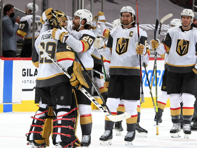 GLENDALE, ARIZONA - MAY 01: Goalie Marc-Andre Fleury #29 of the Vegas Golden Knights is congratulated by Chandler Stephenson #20 of the Golden Knights and teammates after a 3-2 overtime victory against the Arizona Coyotes during the NHL hockey game at Gila River Arena on May 01, 2021 in Glendale, Arizona.