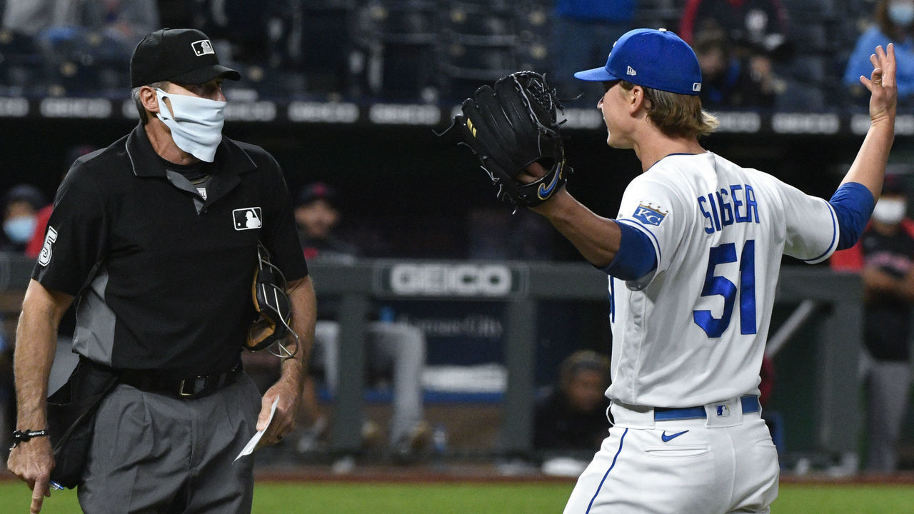 KANSAS CITY, MISSOURI - MAY 05: Starting pitcher Brady Singer #51 of the Kansas City Royals gestures to plate umpire Angel Hernandez as he leaves a game against the Cleveland Indians in the sixth inning at Kauffman Stadium on May 05, 2021 in Kansas City, Missouri.