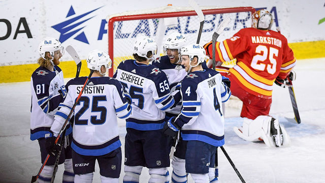 CALGARY, AB - MAY 05: Winnipeg Jets Right Wing Blake Wheeler (26) celebrates with Winnipeg Jets Center Mark Scheifele (55), Winnipeg Jets Left Wing Kyle Connor (81) Winnipeg Jets Left Wing Paul Stastny (25) and Winnipeg Jets Defenceman Neal Pionk (4) after scoring during the third period of an NHL game where the Calgary Flames hosted the Winnipeg Jets on May 5, 2021, at the Scotiabank Saddledome in Calgary, AB.