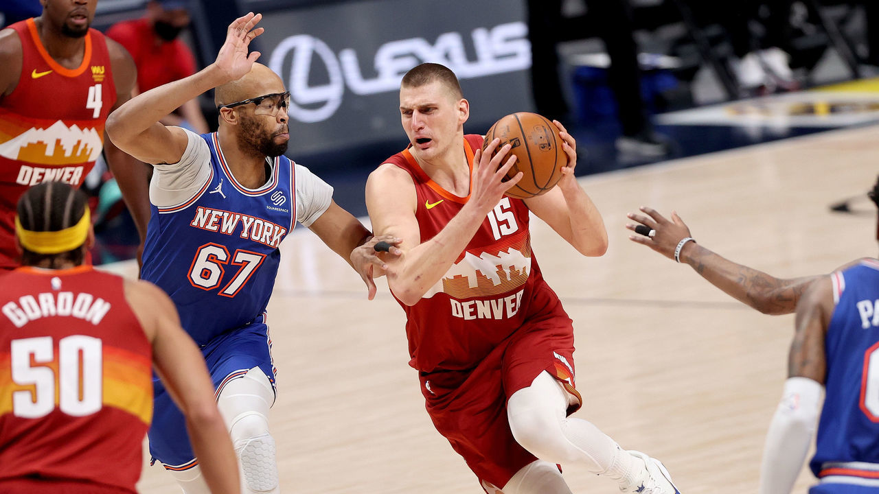 DENVER, COLORADO - MAY 05: Nikola Jokic #15 of the Denver Nuggets drives against Taj Gibson #67 of the New York Knicks in the first quarter at Ball Arena on May 05, 2021 in Denver, Colorado.
