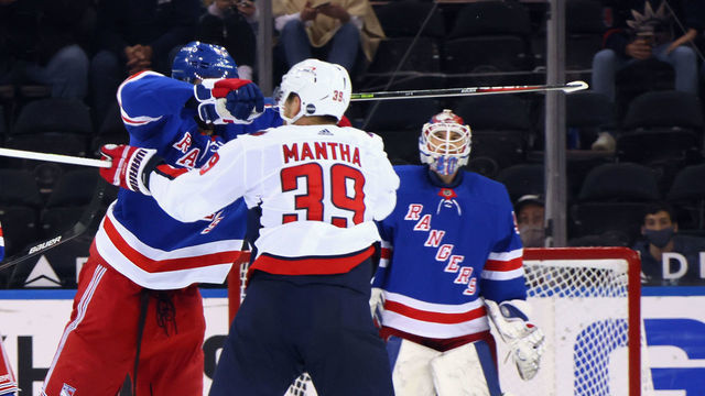 NEW YORK, NEW YORK - MAY 05: Pavel Buchnevich #89 of the New York Rangers takes a high-sticking penalty on Anthony Mantha #39 of the Washington Capitals during the second period at Madison Square Garden on May 05, 2021 in New York City.