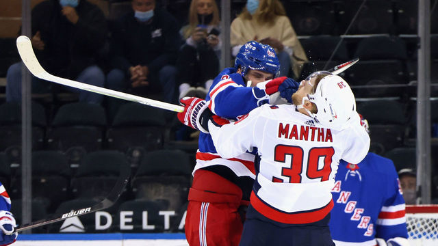NEW YORK, NEW YORK - MAY 05: Pavel Buchnevich #89 of the New York Rangers takes a high-sticking penalty on Anthony Mantha #39 of the Washington Capitals during the second period at Madison Square Garden on May 05, 2021 in New York City.