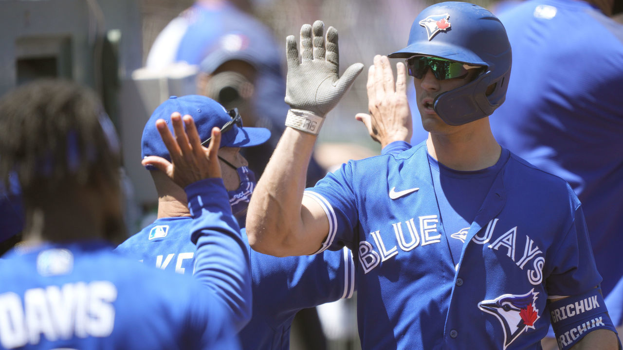 OAKLAND, CALIFORNIA - MAY 06: Randal Grichuk #15 of the Toronto Blue Jays is congratulated by teammates after he hit a three-run home run against the Oakland Athletics in the third inning at RingCentral Coliseum on May 06, 2021 in Oakland, California.