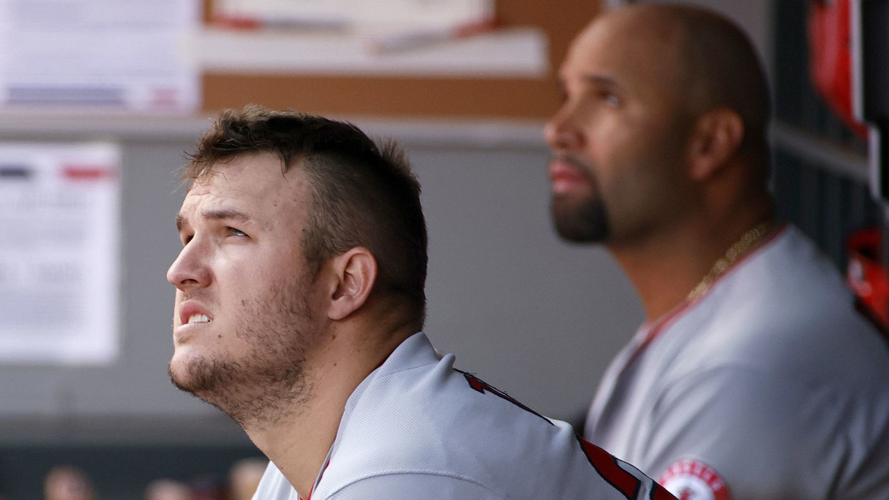 SEATTLE, WASHINGTON - MAY 02: Mike Trout #27 and Albert Pujols #5 of the Los Angeles Angels look on from the dugout during the game against the Seattle Mariners at T-Mobile Park on May 02, 2021 in Seattle, Washington.