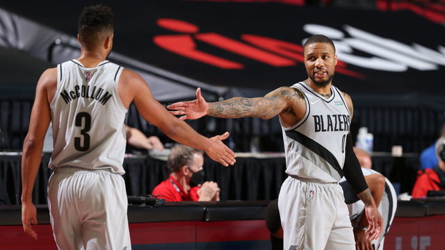 PORTLAND, OR - MAY 7: Damian Lillard #0 of the Portland Trail Blazers high-fives teammate CJ McCollum #3 during the game against the Los Angeles Lakers on May 7, 2021 at the Moda Center Arena in Portland, Oregon. Mandatory Copyright Notice: Copyright 2021 NBAE